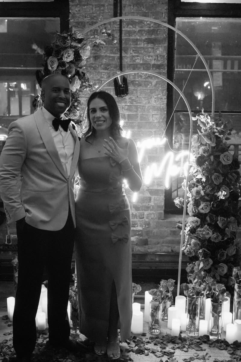 Alexandra and André posing together after the proposal, Alexandra showing her ring