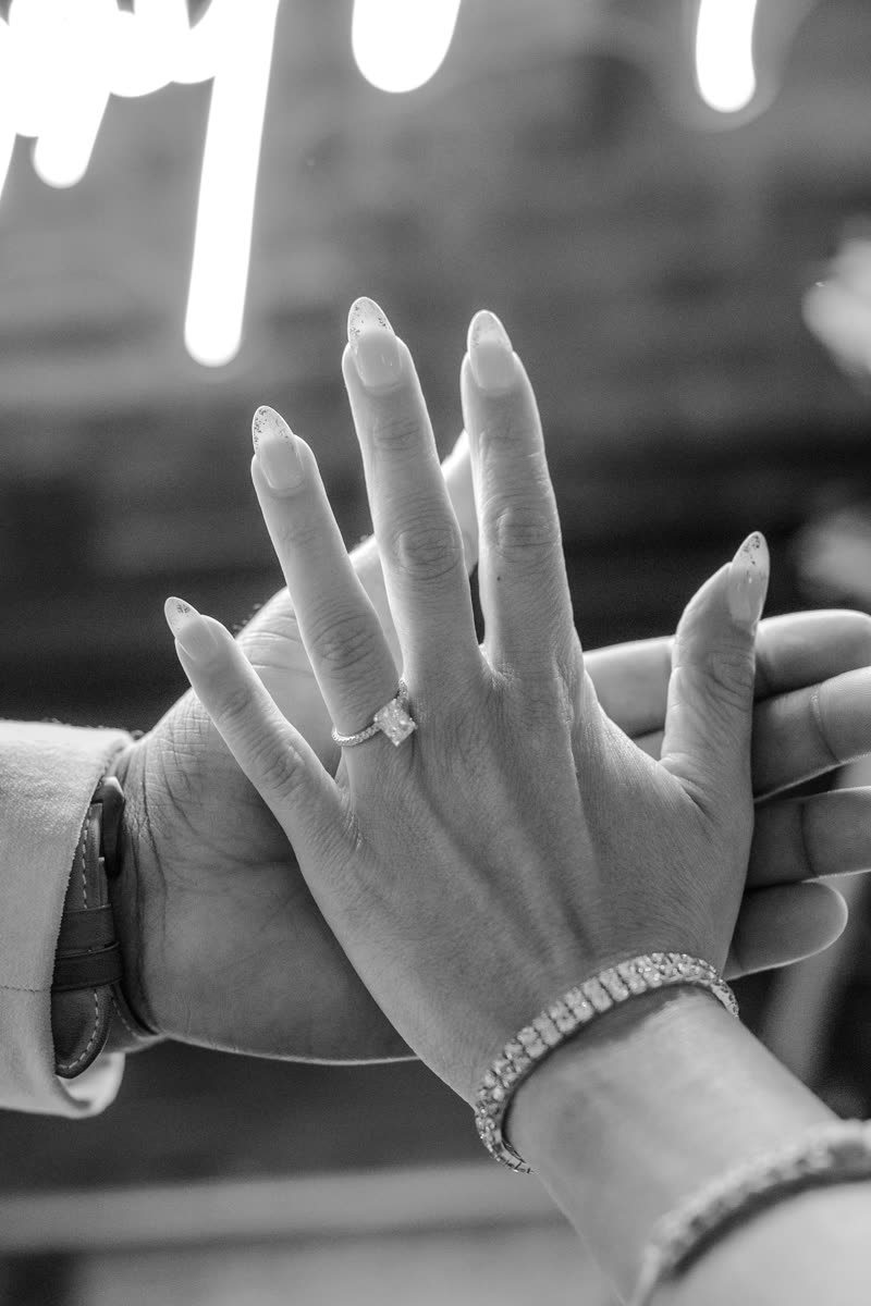 Alexandra’s hand with her engagement ring resting on André’s hand
